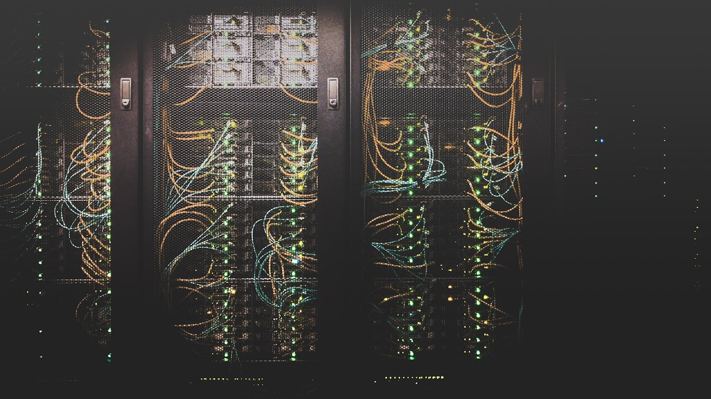Network equipment and cables behind mesh doors in server cabinets.