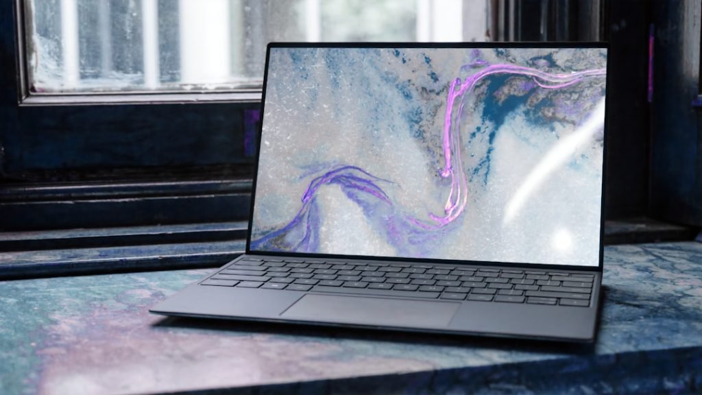 Dell laptop displaying an abstract desktop background; a representative device photograph.
