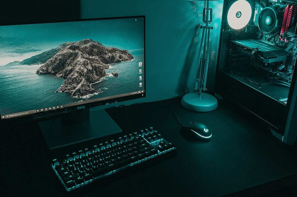Desktop monitor beside a transparent PC tower with illuminated internal components