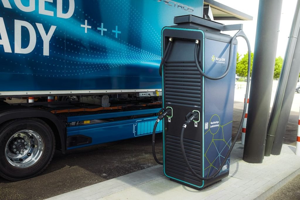 Electric heavy-duty truck connected to a charging station