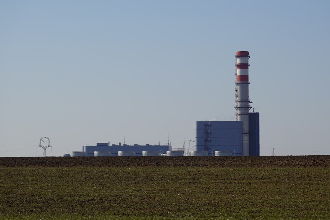 Malženice gas power plant in Slovakia with power lines and a red-and-white chimney.