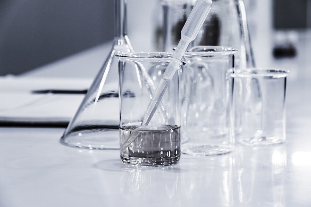 Clear laboratory glassware on a work bench.