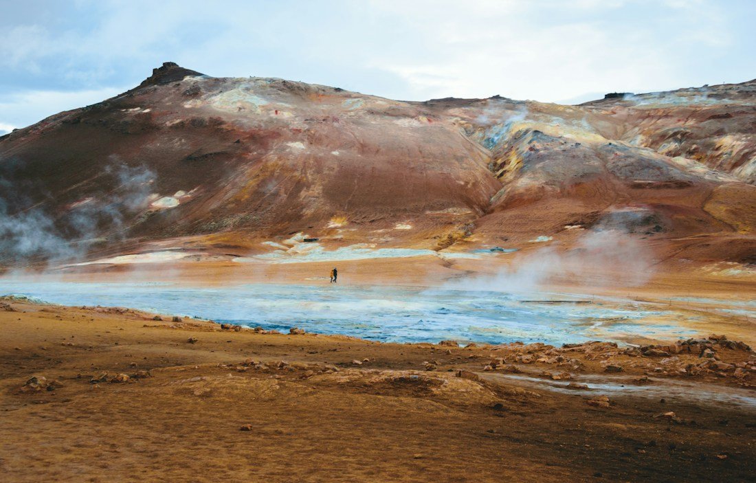 Steam rising above a geothermal landscape in Iceland