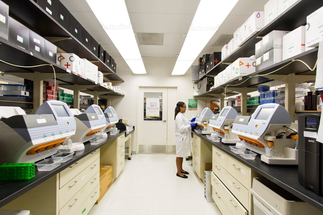 A researcher working among laboratory sequencing instruments.