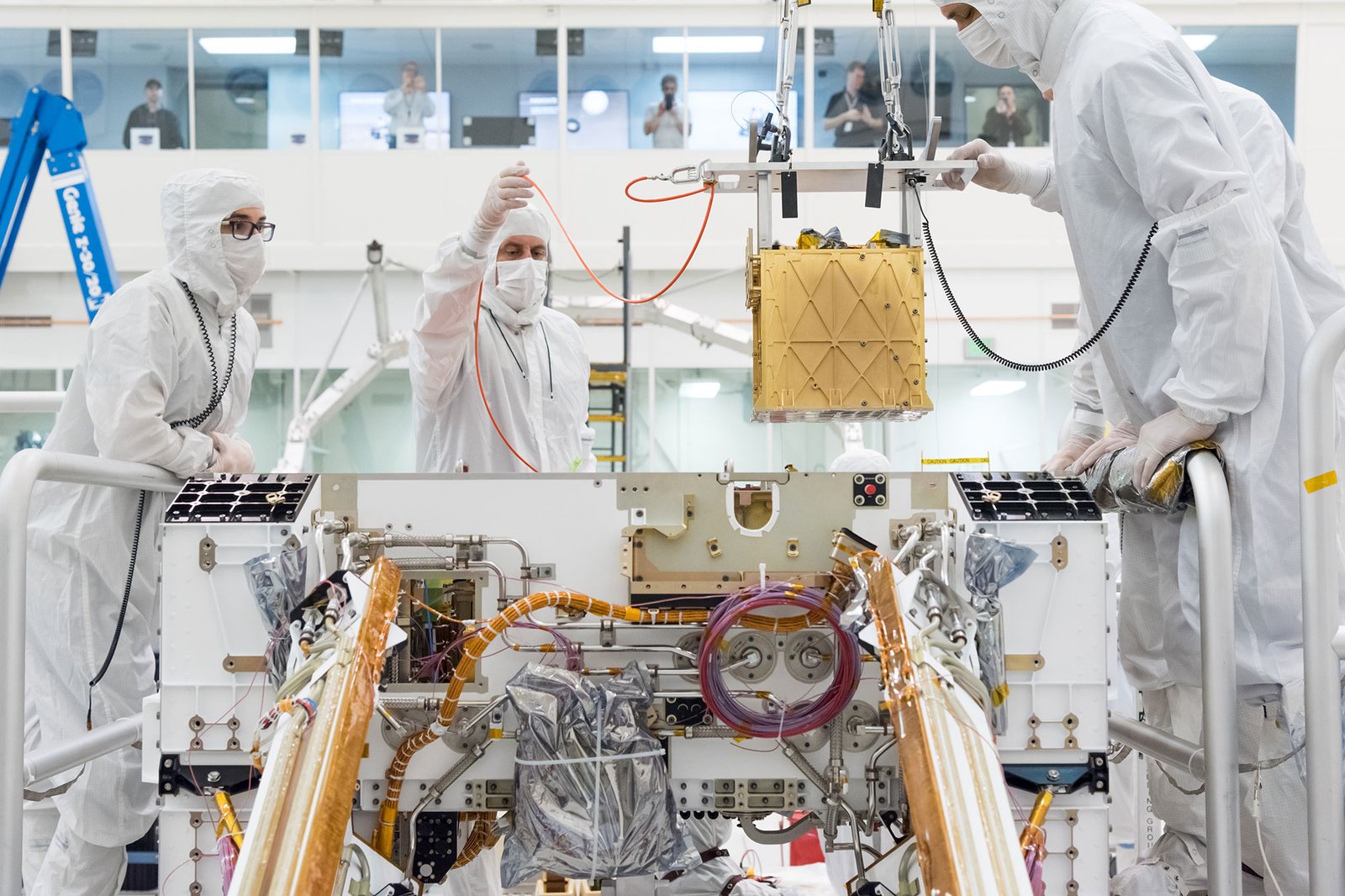 Engineers installing the MOXIE oxygen-production instrument in the Perseverance rover in 2019.