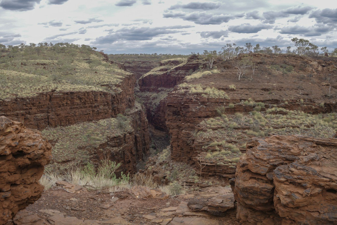 Red rock gorge with sparse vegetation, a representative landscape for the geology story