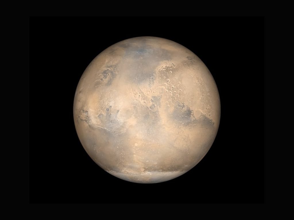 NASA simulated view of Mars against the darkness of space.