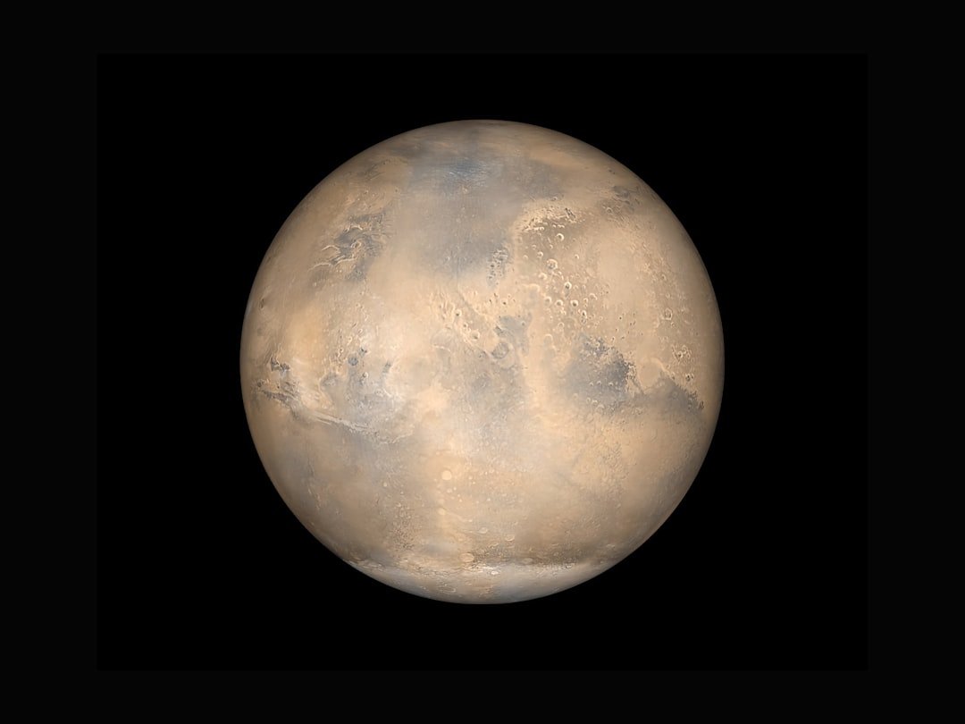 NASA simulated view of Mars against the darkness of space.