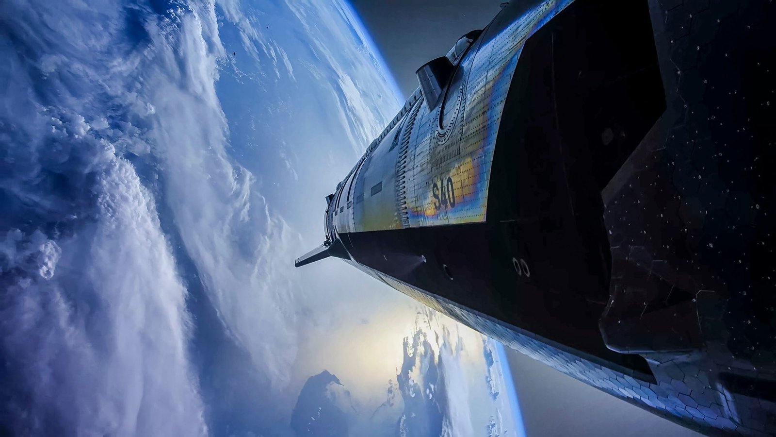 Starship’s tiled exterior with the curved Earth and clouds in the background