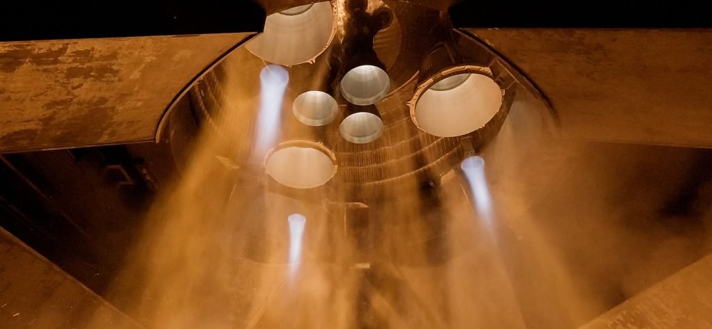 View beneath Starship showing its engine bells during a firing