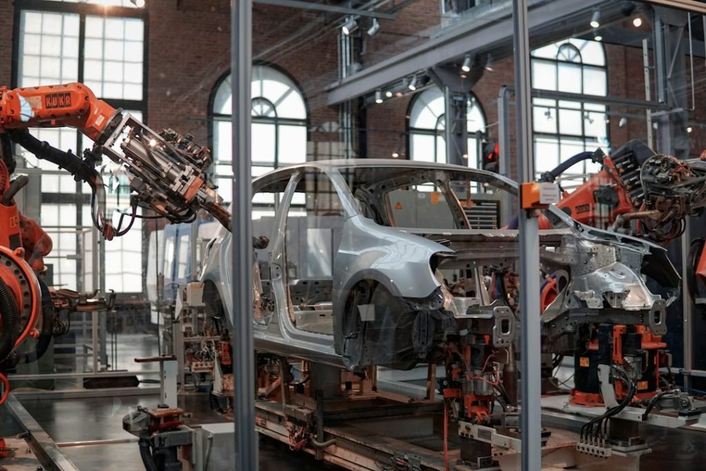 Vehicle body being assembled by industrial robots; representative photograph.