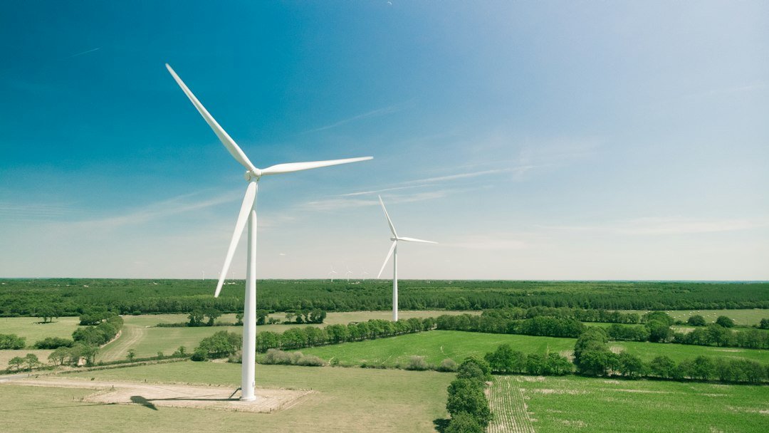 White wind turbines in a wind farm; representative photograph.
