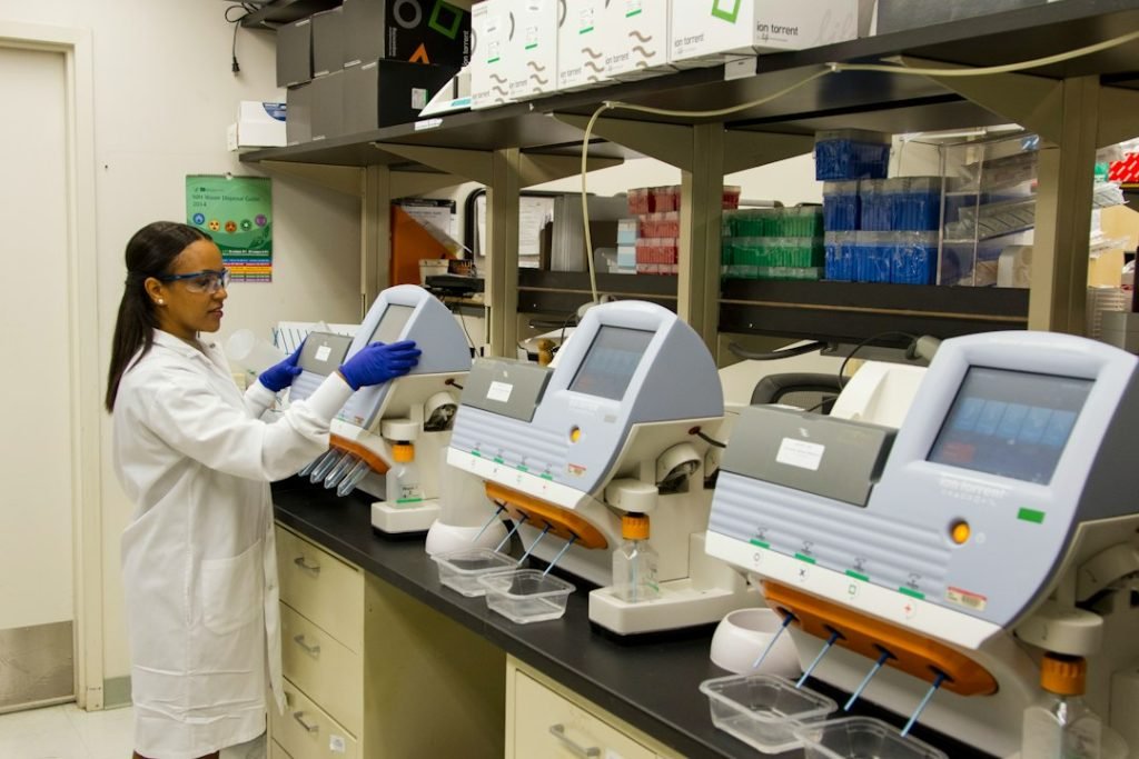 Technician validating genetic variants in a cancer genomics laboratory