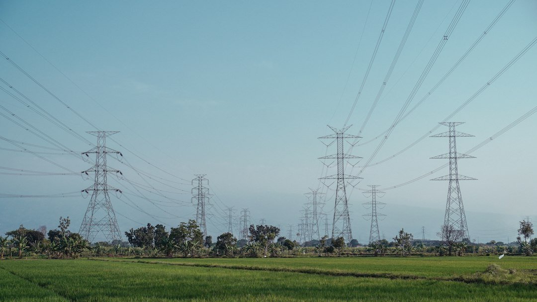 High-voltage transmission towers crossing an open field