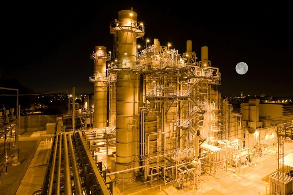 An illuminated industrial power facility at night