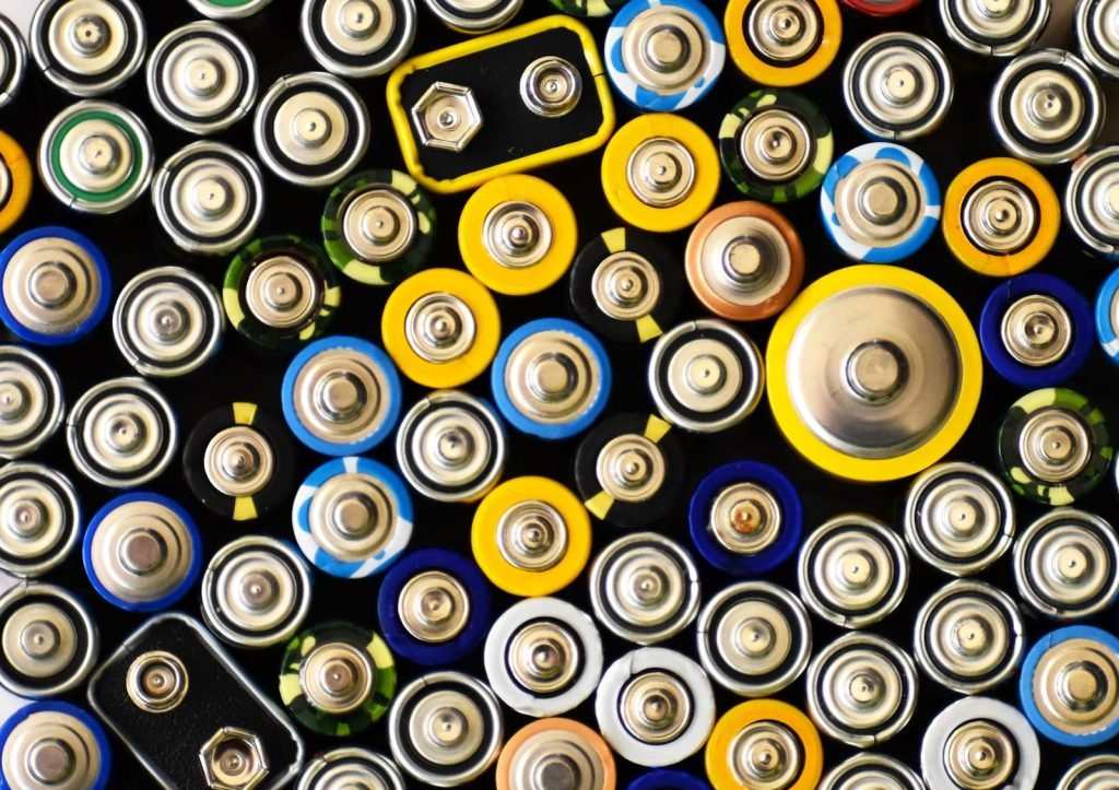 Close view of terminals on assorted cylindrical and rectangular batteries