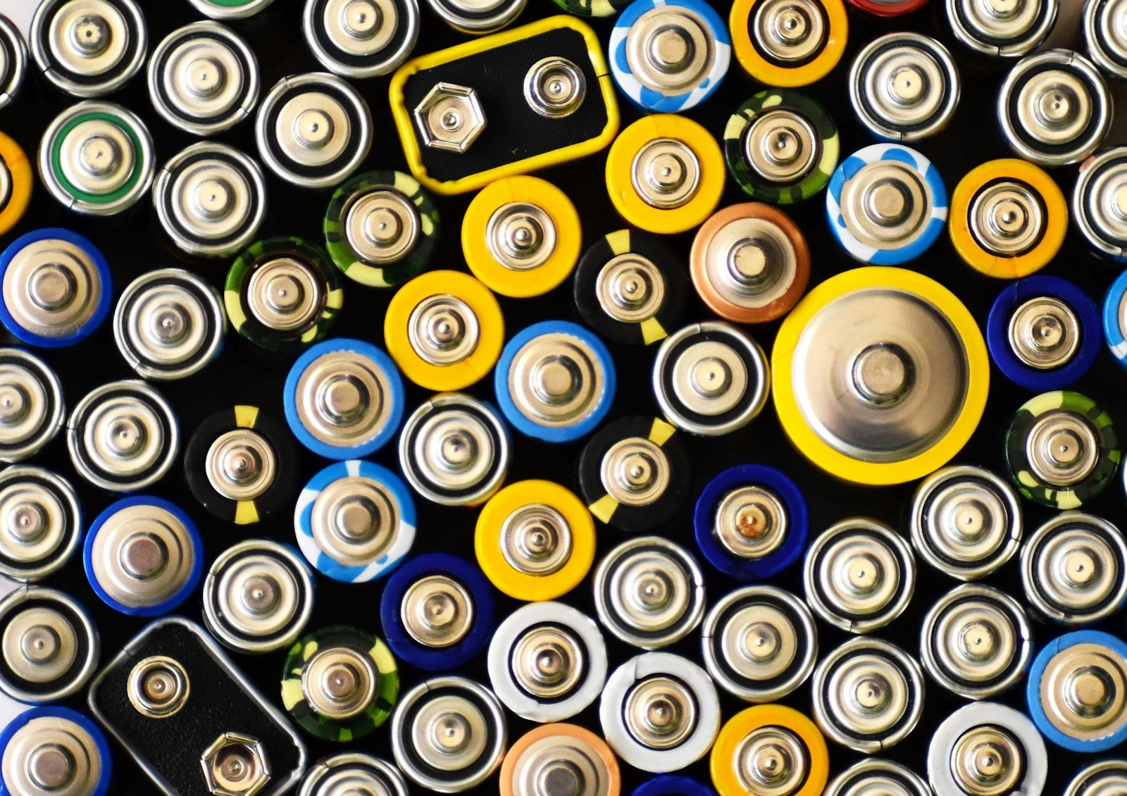 Close view of terminals on assorted cylindrical and rectangular batteries