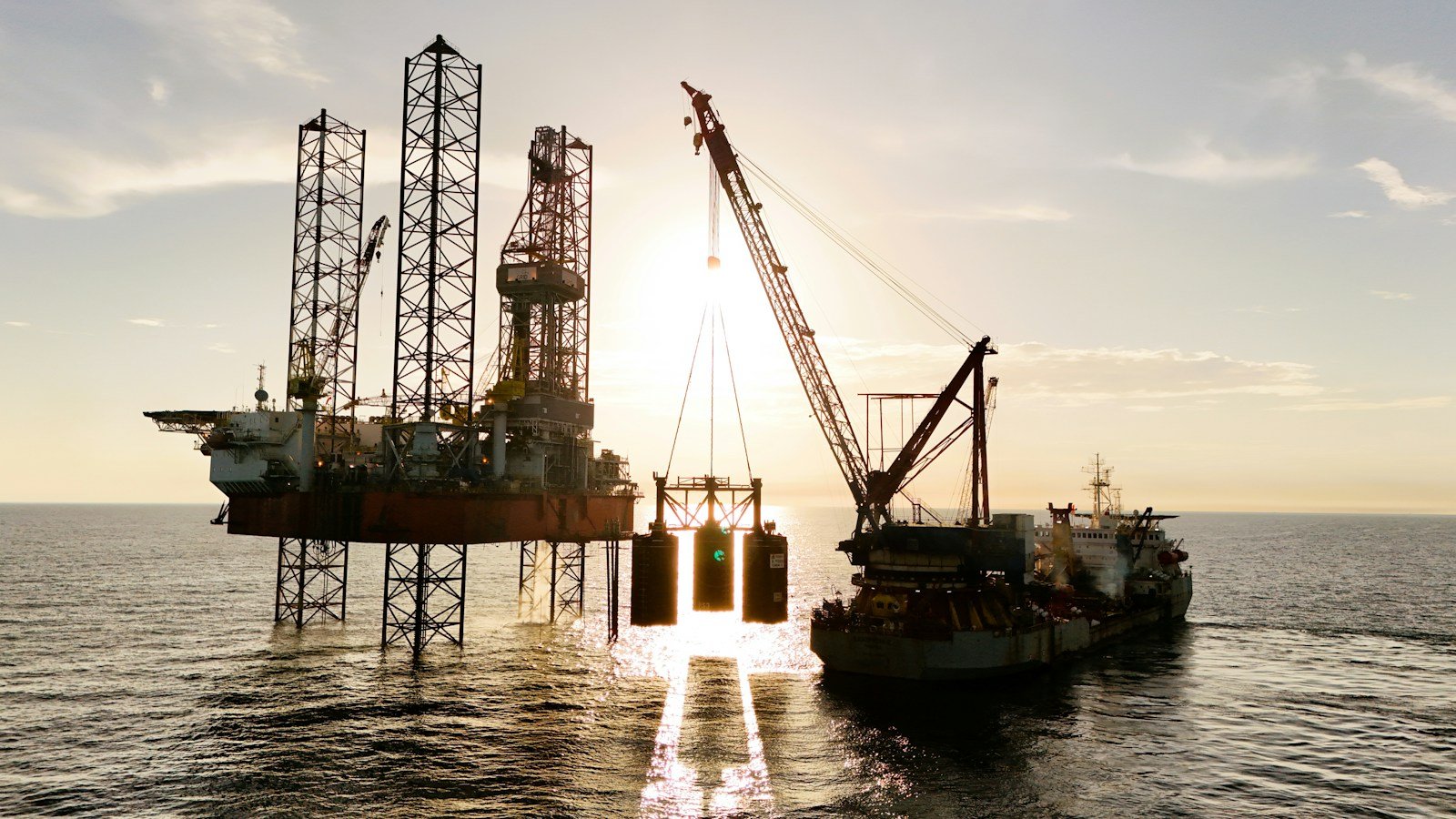 A crane vessel lifting a structure beside an offshore platform