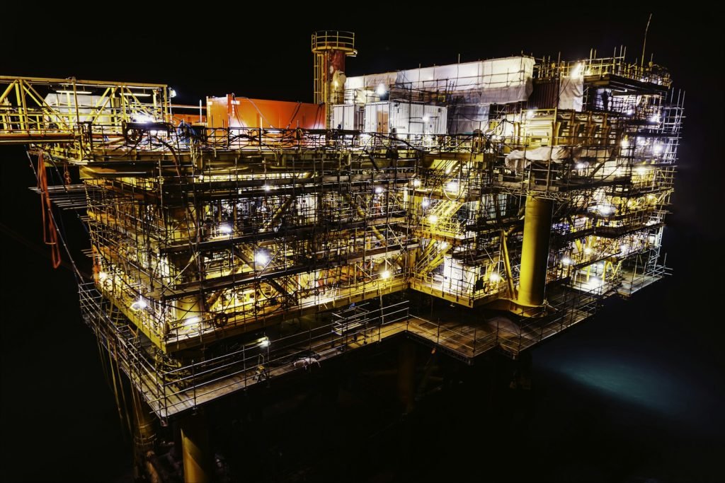 An offshore industrial platform illuminated at night