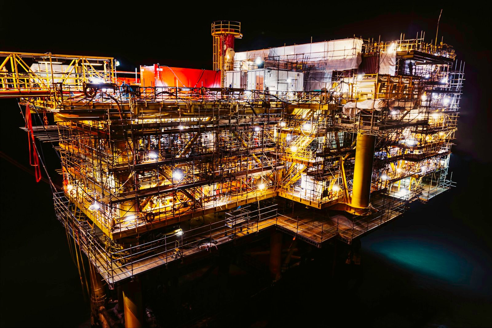 An offshore industrial platform illuminated at night