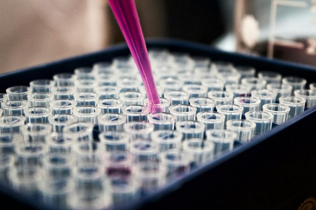 Pipette dispensing liquid into small laboratory tubes