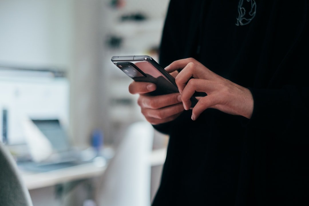Hands holding a smartphone, illustrating conversational technology