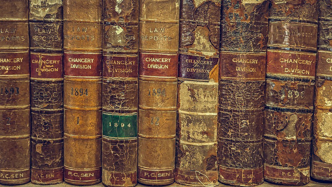Antique law books with worn leather bindings on a shelf