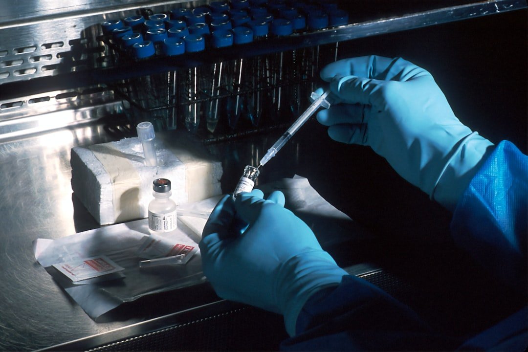 Gloved researcher handling samples under a laboratory hood