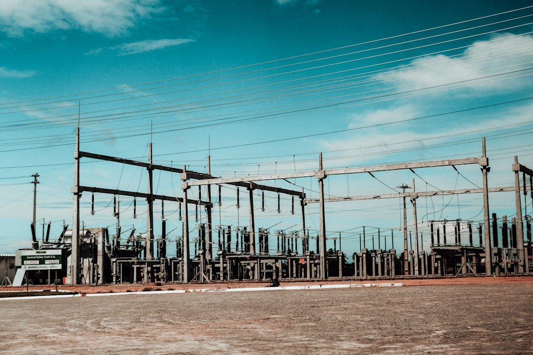 Electrical substation and transmission lines under a blue sky